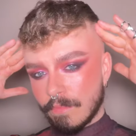 Pro Artist Ed wearing a pride makeup look using the Summer of Lovegasm collection