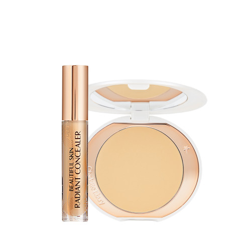 Concealer in a glass tube with a gold-coloured lid and a pressed powder in a banana yellow shade in a white-coloured compact. 