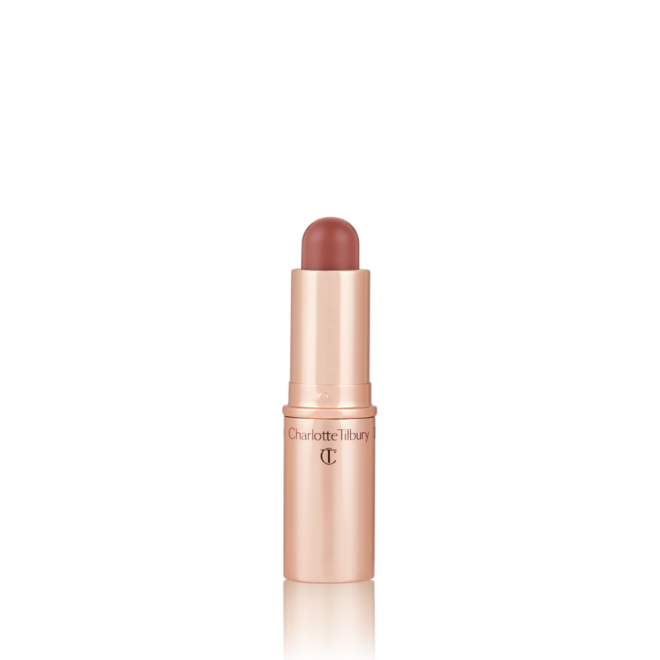 An open, lip and cheek colour stick in a glowy brown-pink shade in a golden-coloured tube.