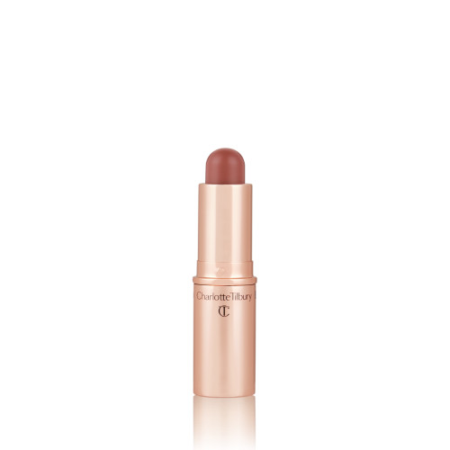 An open, lip and cheek colour stick in a glowy brown-pink shade in a golden-coloured tube.