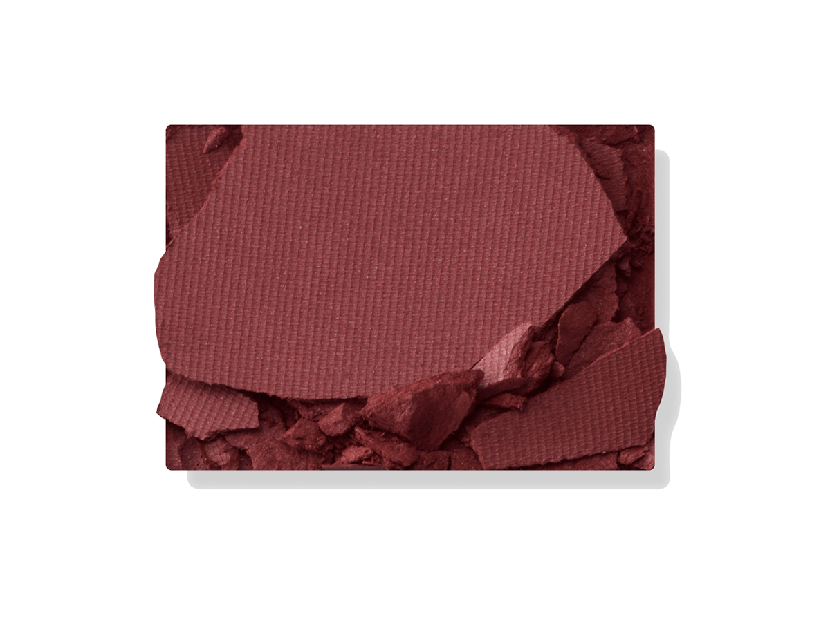 Swatch of a matte eyeshadow in a purplish red shade.