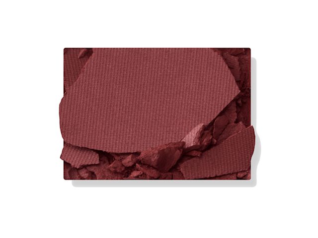 Swatch of a matte eyeshadow in a purplish red shade.