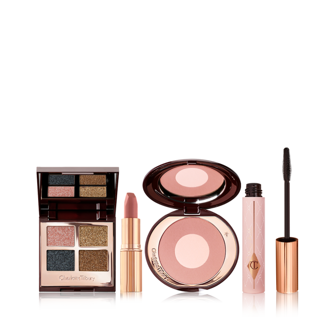 Open, quad eyeshadow palette with a mirrored-lid with shimmery shades of teal, rose gold, bronze, and dark brown, nude pink matte lipstick, two-tone blush compact in rose gold and champagne, black mascara in a nude pink bottle with a gold and black-coloured applicator.