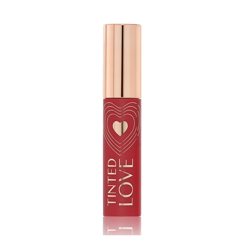A closed lip and cheek tint with a gold-coloured lid in a vibrant-red-coloured tube. 