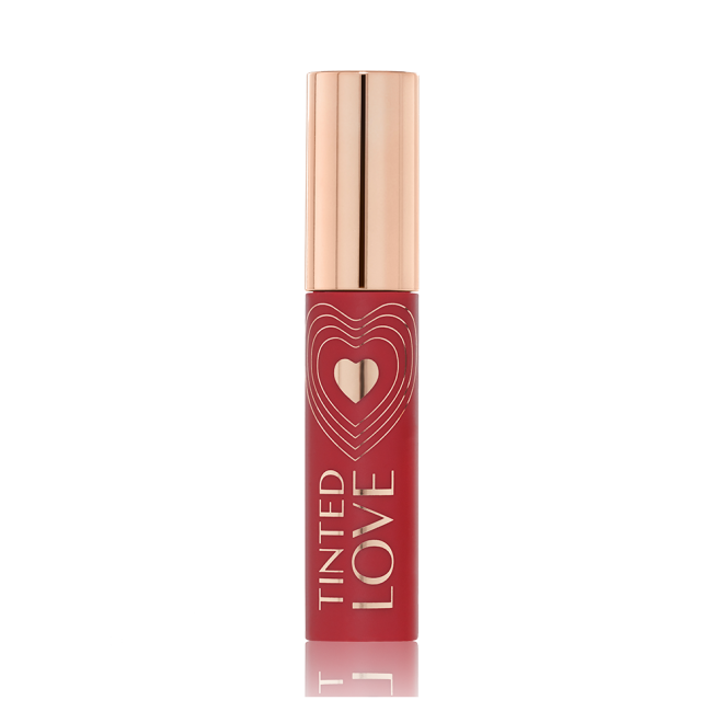 A closed lip and cheek tint with a gold-coloured lid in a vibrant-red-coloured tube. 