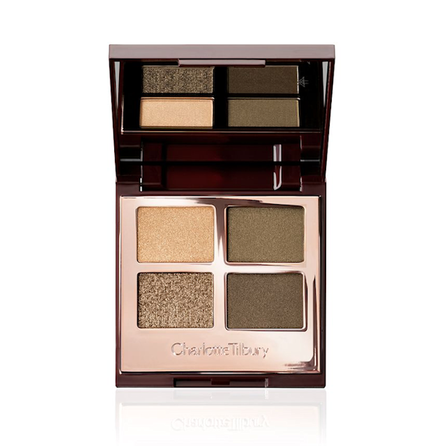 An open, mirrored-lid quad eyeshadow palette with eyeshadows in shades of shimmery dark green, olive, light green, and light gold. 