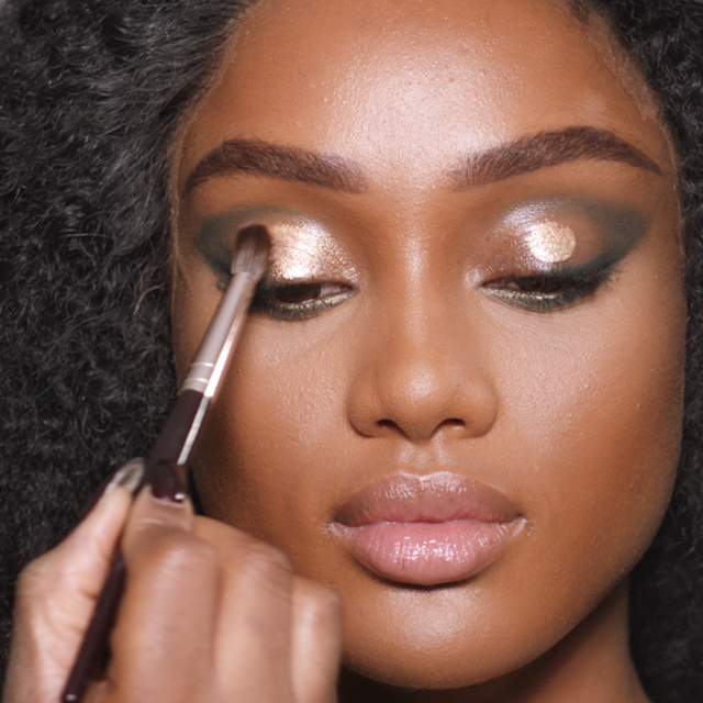 Step 4 in Charlotte's 70s makeup tutorial is illuminating the eyes with golden highlighter