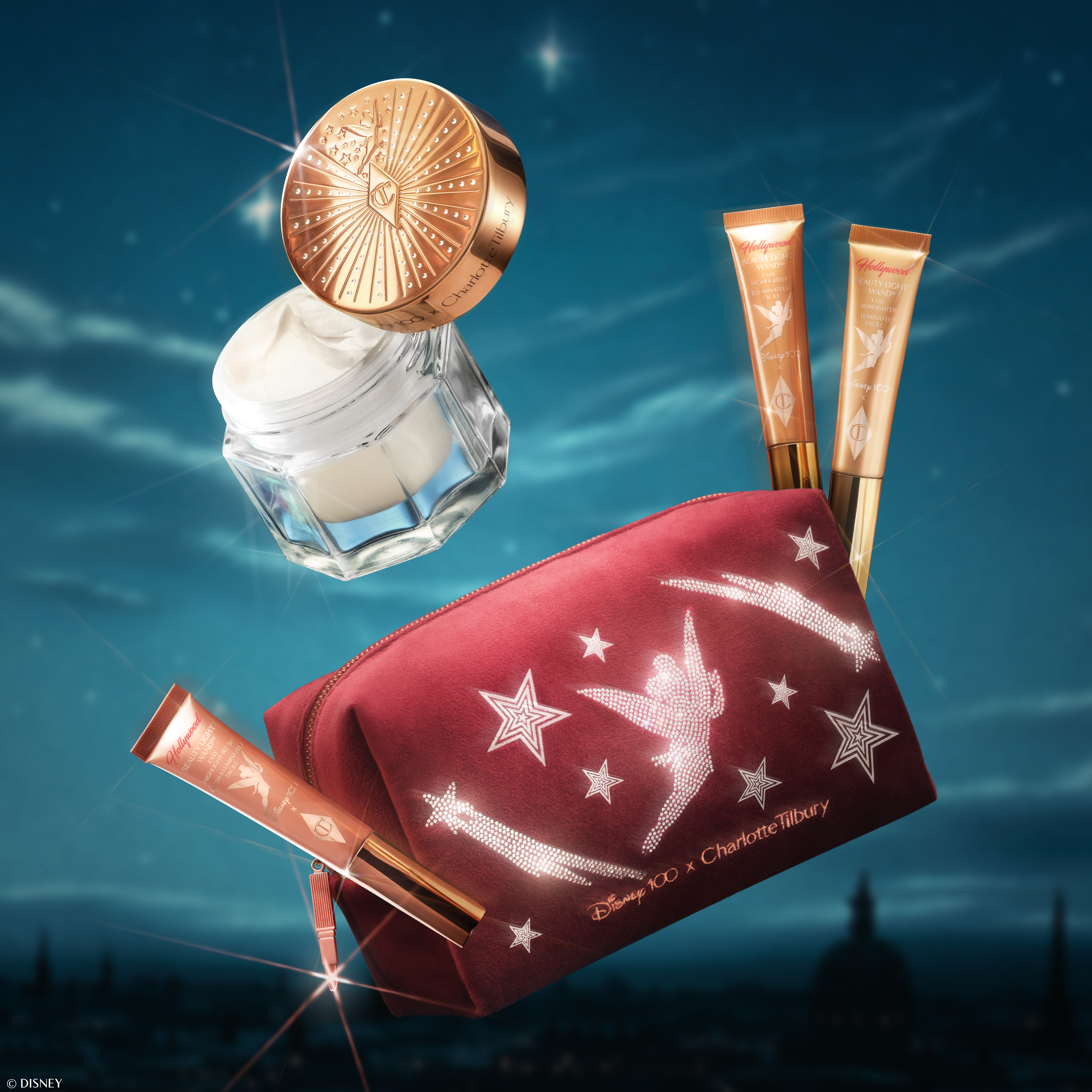 Disney 100 x Charlotte Tilbury limited-edition beauty products on a night sky backdrop