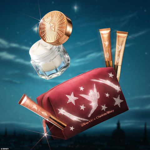 Disney 100 x Charlotte Tilbury limited-edition beauty products on a night sky backdrop
