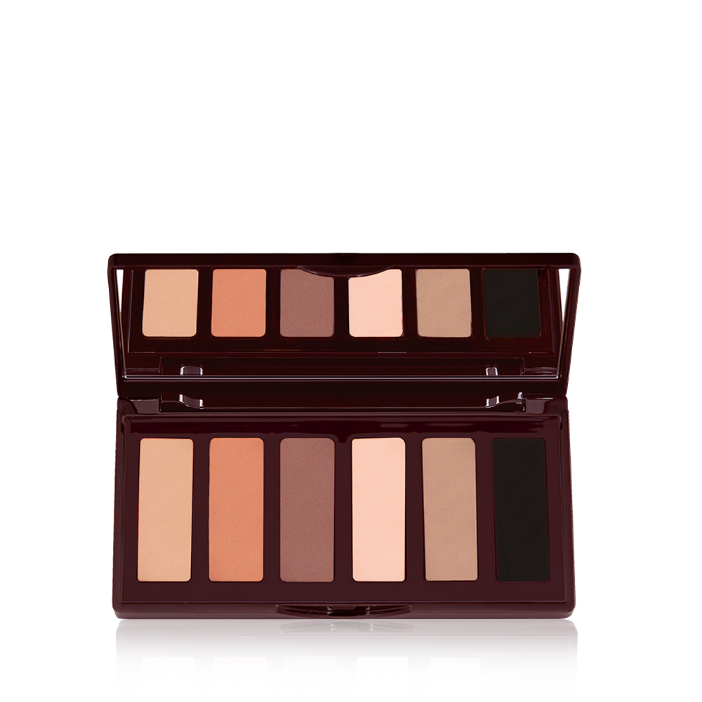 An open, mirrored-lid, 6-pan eyeshadow palette in shimmery and matte nude shades. 