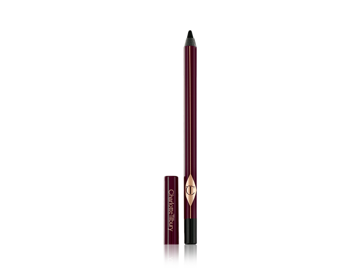 An open, black kohl eyeliner pencil with its lid next to it. 