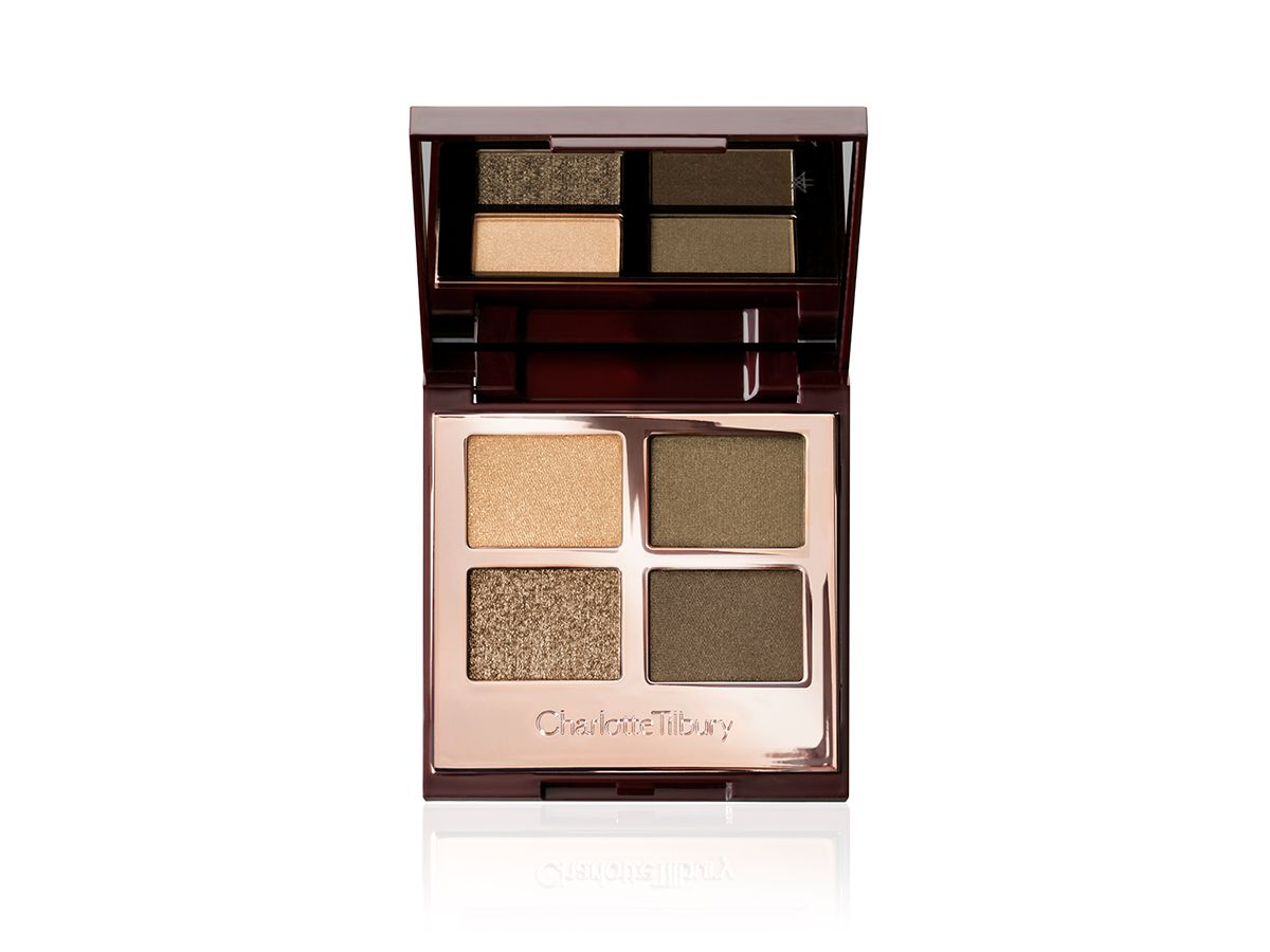 An open, quad eyeshadow palette in rose gold, metallic packaging with a mirrored lid having dark green, olive green, khaki, and golden eyeshadows. 