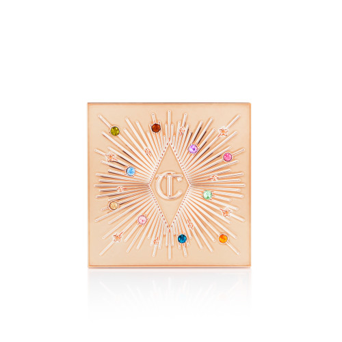A closed, one-pan eyeshadow compact in light golden colour with colourful stones all over the lid.