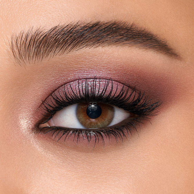 Single-eye close-up of a light-tone model with hazel eyes wearing shimmery lilac-coloured duo-chrome eyeshadow.