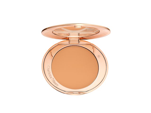 An open-pressed powder compact in a sandy brown shade. 