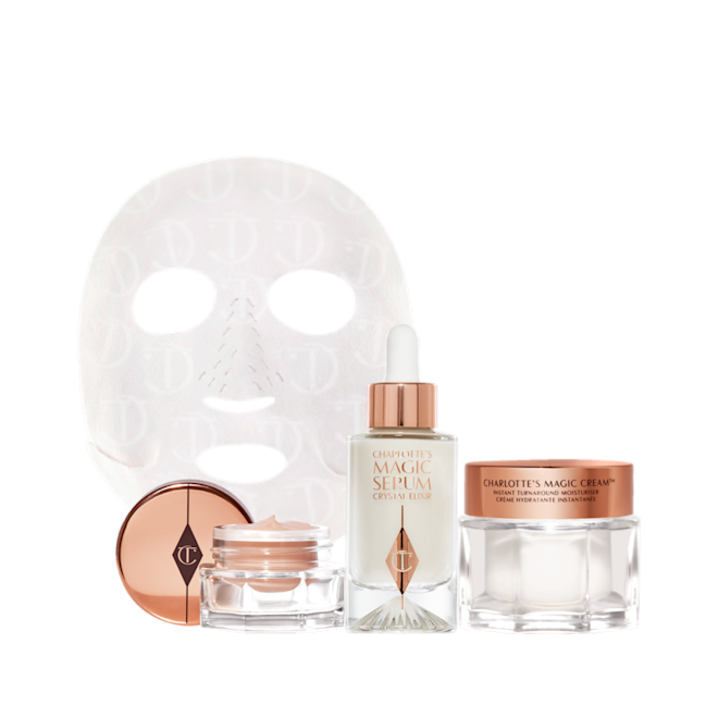 Glowing Night in a Box displayed Eye cream in an open glass pot with a gold-coloured lid, dry sheet mask, luminous, ivory-coloured serum in a glass bottle with a white and gold-coloured dropper lid, pearly-white face cream in a glass jar with a gold-coloured lid.