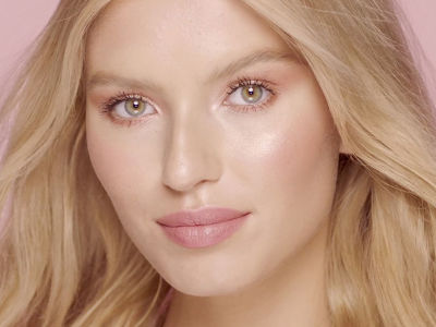 Video tutorial of a glowy, nude-pink makeup look on a fair-tone model with green eyes. 