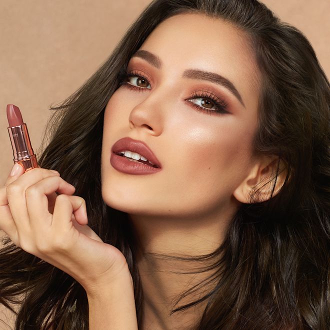 Matte Revolution The Super Nudes in Super Fabulous on medium-tone model Medium-tone model with brown eyes wearing smokey brown eyeshadow with a deep, sultry rose-brown nude lipstick with a matte finish.