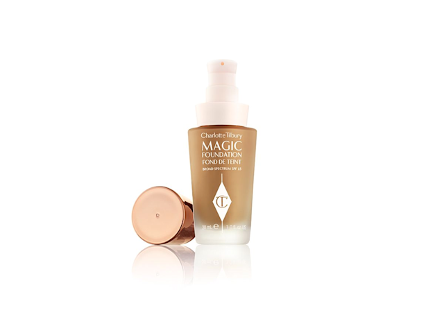 An open foundation in a medium dark shade in a frosted glass bottle with a rose gold coloured lid. 