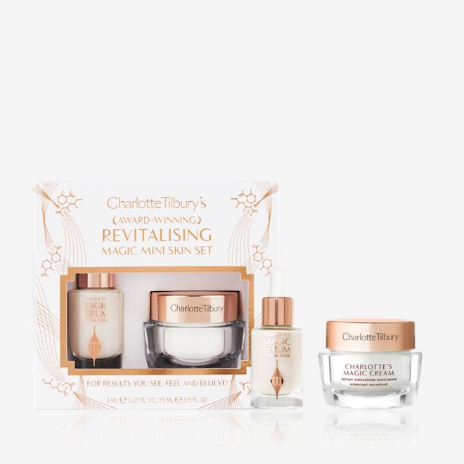 Revitalising Mini Skincare Kit with box displayed Travel-size ivory-coloured luminous serum in a glass bottle and travel-size pearly-white face cream in a glass jar with a gold-coloured lid.