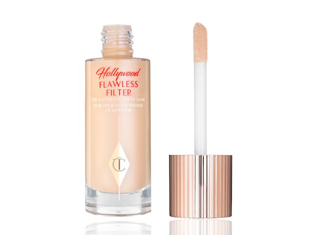 A glow-booting serum-primer in a clear, glass bottle with its doe-foot applicator lid next to it. 