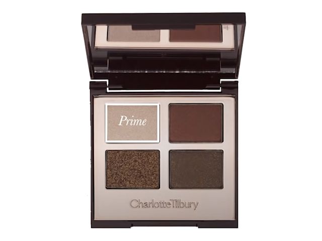 An open, mirrored-lid quad eyeshadow palette with eyeshadows in shades of shimmery brown, dark brown, grey-brown, and dark beige, with prime written on the dark beige shade. 