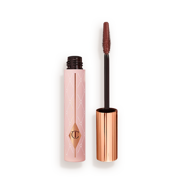 An open tube of a chocolate-brown-coloured mascara in a pink-coloured tube with a gold-coloured lid. 