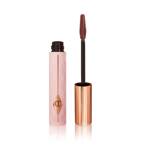 An open tube of a chocolate-brown-coloured mascara in a pink-coloured tube with a gold-coloured lid. 