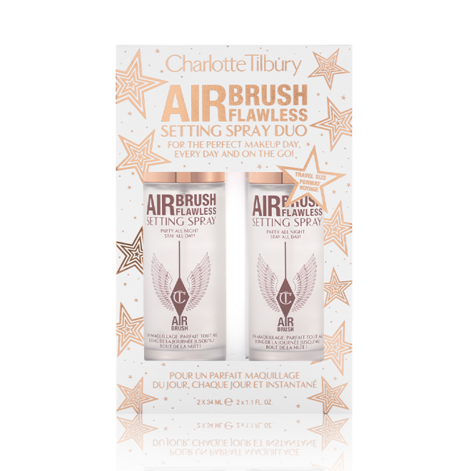 Two, identical, mini setting sprays in a white and gold-coloured packaging box with gold stars printed all over with text on the box that reads, 'Charlotte Tilbury. Airbrush Flawless Setting Spray duo'