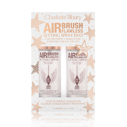 Two, identical, mini setting sprays in a white and gold-coloured packaging box with gold stars printed all over with text on the box that reads, 'Charlotte Tilbury. Airbrush Flawless Setting Spray duo'