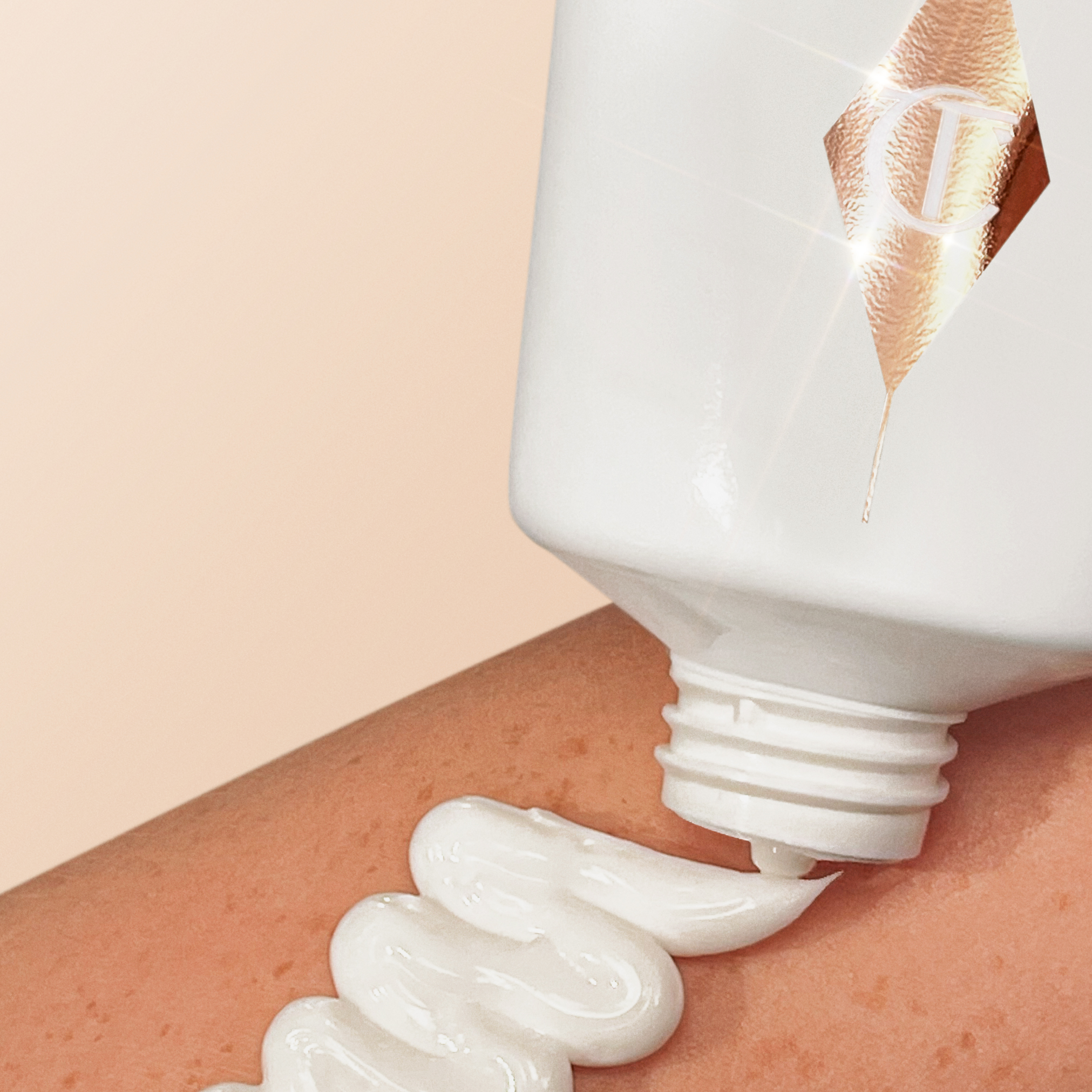 Close up of Charlotte's Magic Body Cream hydrating body moisturiser being applied to a model's arm