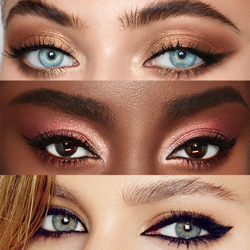 Three fair, tan, and deep-tone models wearing smokey eye looks with black eyeliner. 