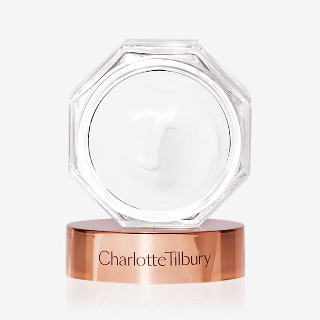 Magic Cream lid removed Thick, pearly-white cream in an open glass jar with its rose-gold-coloured lid next to it.