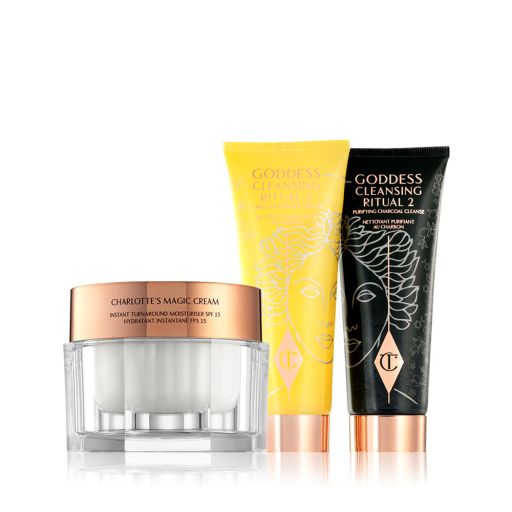 A pearly-white face cream in a glass jar with two facial cleansers, one in lemon-yellow and the other in charcoal-black packaging, all three with rose-gold-coloured lids. 