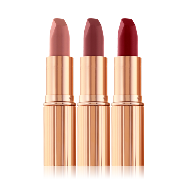 Three open matte lipsticks in nude pink, terracotta, and wine shades