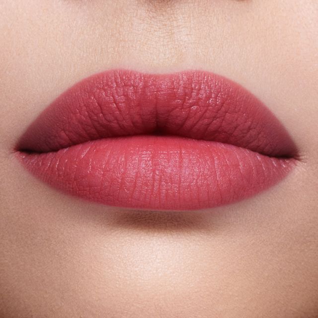 Redheaded model wearing Airbrush Flawless Lip Blur pink lipstick in Rose Blur