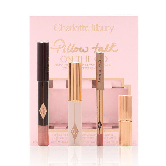 An unpacked makeup kit that includes an eyeshadow pencil in a rose gold shade, mascara, lip liner pencil in nude pink, and lipstick in a nude pink shade with the packaging box in a nude pink colour behind the products.