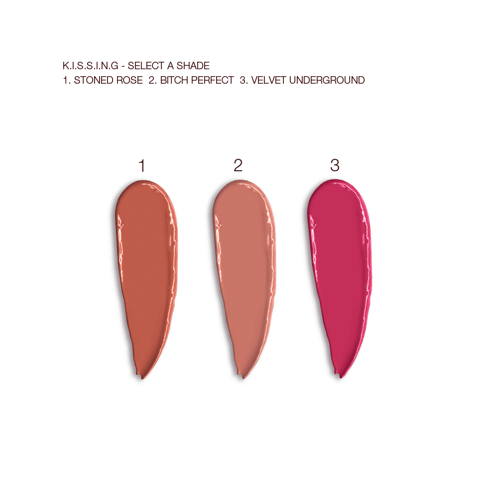 Swatches of three satin-finish lipsticks in terracotta, nude peach, and magenta. 