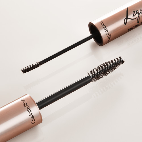 Brush head of an eyebrow gel with thick bristles for easy application and brush head of an eyebrow tint with thin bristles for precise application, both in a black and rose-gold colour scheme.