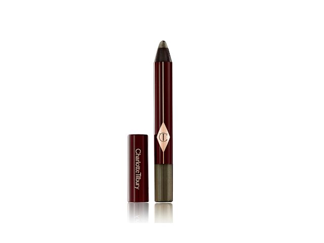 An open, chubby eyeshadow stick in smokey green colour with its lid next to it.