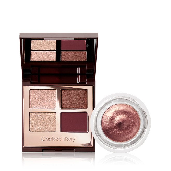 An open, mirrored-lid eyeshadow palette with four shimmery and matte eyeshadows in champagne, rose gold, dark brown, and smokey red shade with an open pot of cream eyeshadow in a dark rose gold shade. 