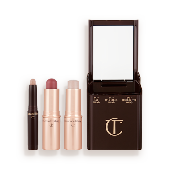 Quick & Easy Instant 5 Minute Pretty Fresh Look Kit products displayed An open shadow stick in a shimmery champagne pink shade, a lip and cheek blush stick in a rich coral shade, and highlighter stick in an opal shade.