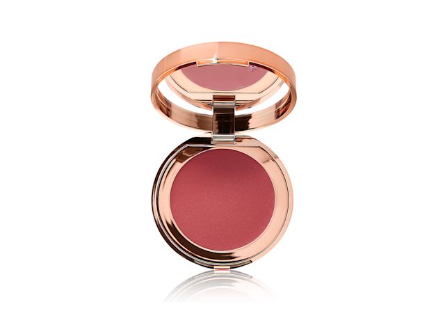 An open, mirrored-lid lip and cheek cream compact in a warm rosebud-pink shade.