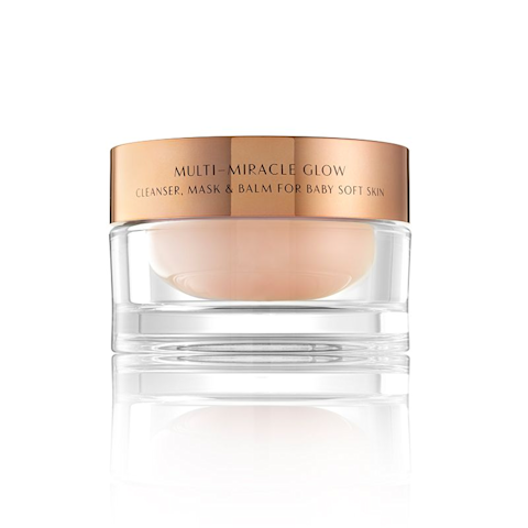 A champagne-coloured cleanser, mask, and balm in a clear jar with a rose-gold, metallic lid.