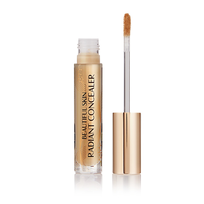 Radiant concealer in a glass tube with its doe-foot applicator next to it with a gold-coloured handle.