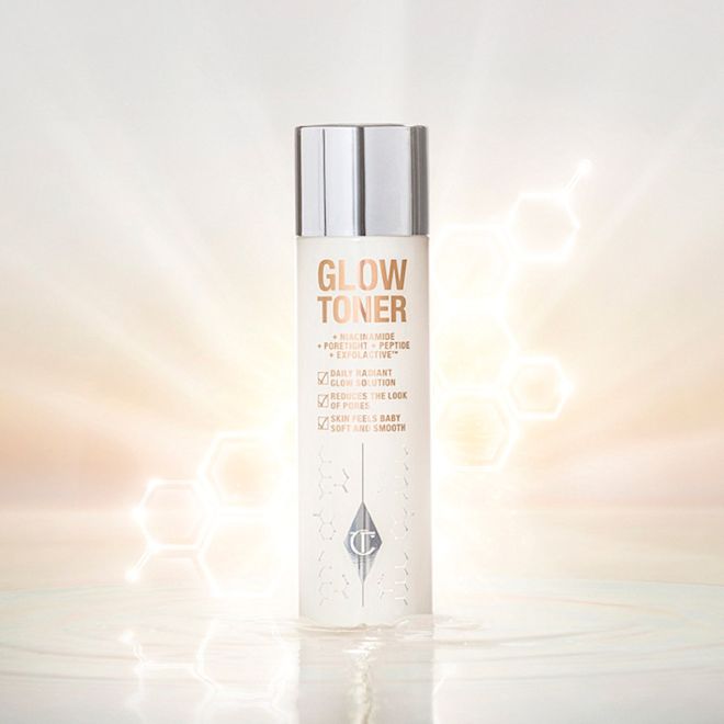 Glow Toner closed A large, clear bottle filled with luminous, cream-coloured watery toner with a silver-coloured lid.