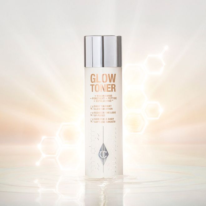 Glow Toner A large, clear bottle filled with luminous, cream-coloured watery toner with a silver-coloured lid.