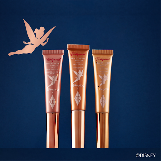 All three Disney100 x Charlotte Tilbury Beauty Light Wands with a Tinkerbell silhouette and night sky backdrop