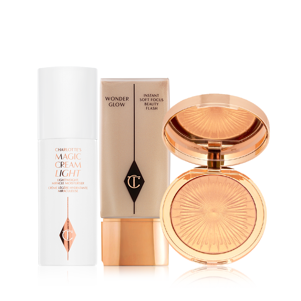 Pearly-white face cream in a glass jar with a gold-coloured lid, foundation in a clear bottle with a gold-coloured lid, and powder highlighter in a soft rose-gold shade in a gold-coloured compact with a mirrored-lid.