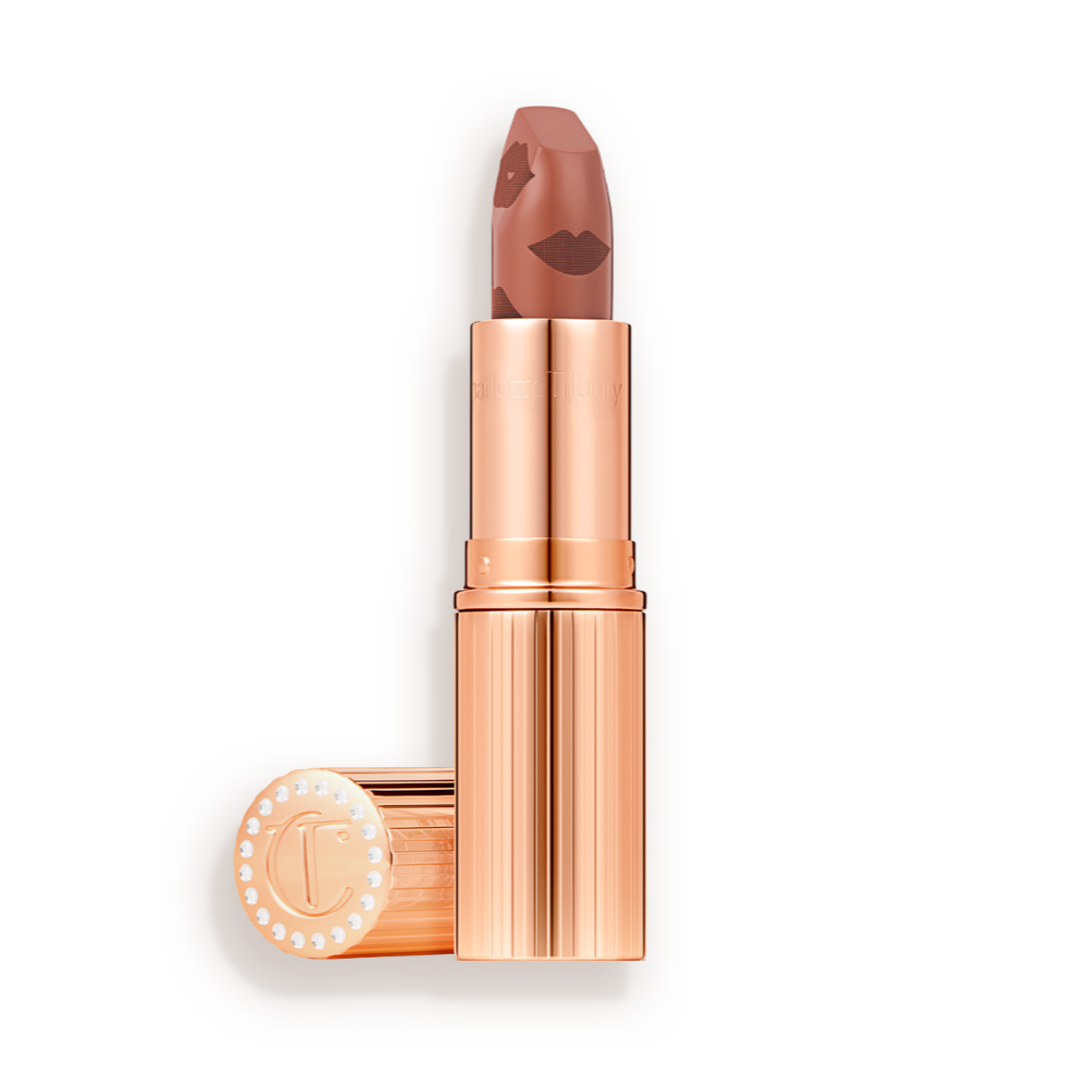  A rosy terracotta coral lipstick with a satin-finish in a gold-coloured tube with its lid next to it.